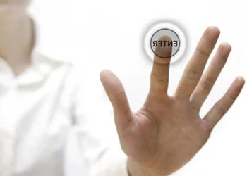 A hand pressing a glass screen saying log in